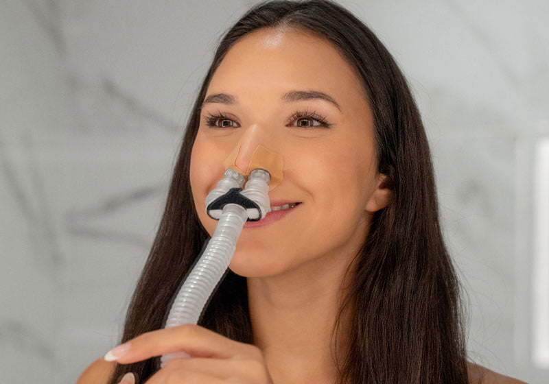 CPAP user fitting a nasal mask through insurance coverage