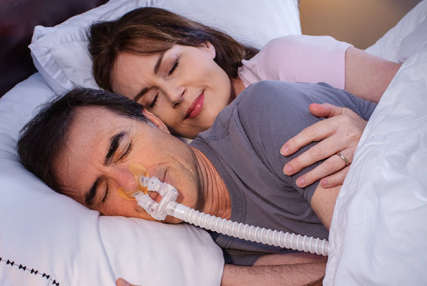 CPAP user sleeping comfortably with an anxiety-friendly mask.